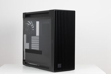 Obraz premium Side view of empty big tower, PC case, chassis, tempered-glass left panel has a mesh window to aid in graphics-card ventilation