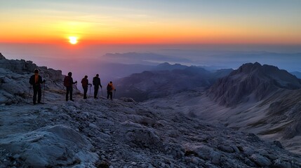 Mountain travel adventure with a group hiking at sunset