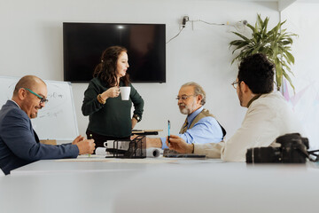 Mexican coworkers discussing project in office