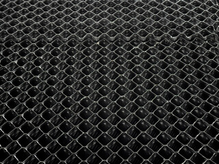 Close up of fabricated black plastic grid, mesh, material in a waste water treatment plant.