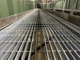 Close up of metal grates and catwalks in an industrial setting showing engineering details 