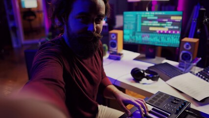 POV of musician playing on synthesizer for online piano lessons in his home studio. Singer songwriter filming vlog teaching about musical instruments, midi controller keyboard. Camera A.