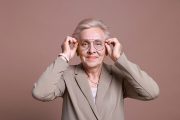 Portrait of senior woman on color background