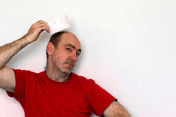 man and a white paper crown. The man is offered a crown. hands hold crown over head. Coronation concept, royal.