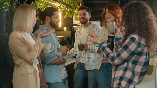Multiethnic colleagues friends male female drinking coffee break in office cafe casual team diverse girls guys millennial students happy smiling business men women mates drink relax friendly talk chat
