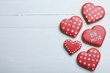 Delicious heart shaped cookies on white wooden table, flat lay with space for text. Valentine's Day