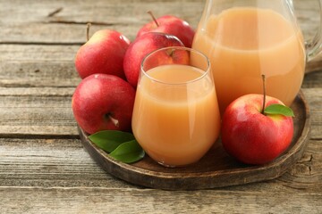 Tasty apple juice and fresh fruits on wooden table, closeup