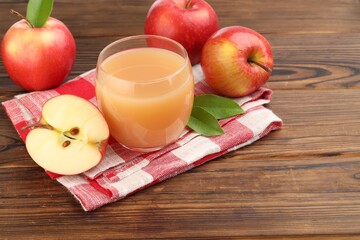 Tasty apple juice and fresh fruits on wooden table, closeup