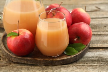 Tasty apple juice and fresh fruits on wooden table, closeup