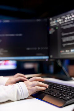 Woman typing on keyboard, implementing security measures to protect company systems and data. Close up shot of IT specialist writing, testing and debugging Java code for software applications,