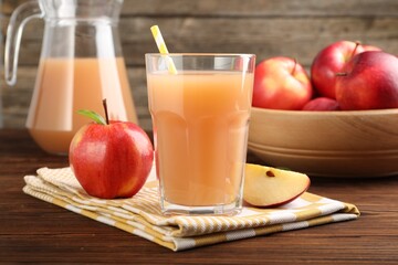 Tasty apple juice and fresh fruits on wooden table, closeup