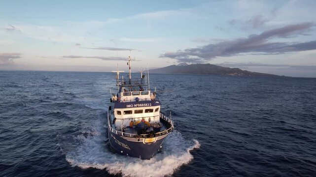 Imagens de um atuneiro navegando nas &aacute;guas cristalinas ao largo da Ilha do Pico, nos A&ccedil;ores, com a majestosa ilha ao fundo.