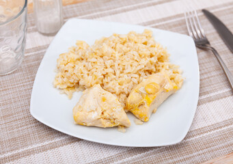 Tender meat of baked chicken breast is garnished with boiled basmati rice. Hearty and easy-to-prepare lunch and dinner.