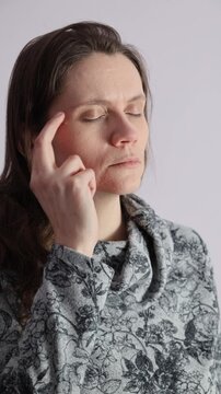 Woman practicing EFT tapping meridian points.