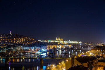 Fototapeta premium Prague, Czech republic - February 23, 2022. Night view of Vysehrad towards to Prague castle and bridges over Moldau river
