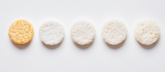 Five varied rice cakes arranged neatly on a clean white background with ample space for text and design elements in a flat lay composition