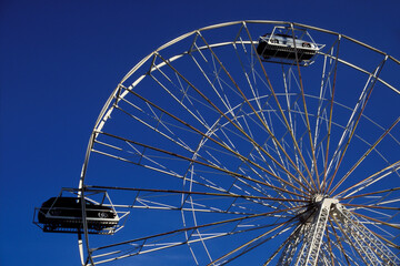 Display of vehicles on a ferris wheel on a blue sky background in Toronto, Canada