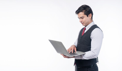 Successful businessman typing laptop looking communication standing over isolated white background. Handsome guy using digital gadget computer connection internet working copyspace.Technology wireless