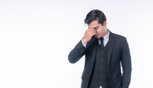 Disappointment unhappy businessman holding hands on nose worry problem over isolated white background. Serious tired handsome man suit distressed holding hands on facd sadness. Upset loss guy despair.
