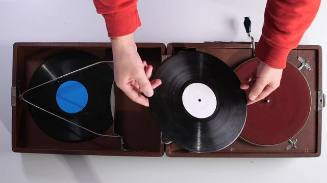 Top view Man holding a vinyl record in his hands. Man choosing what music to listen to