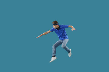 Obraz premium Handsome skater jumping on light blue background