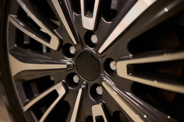 Detailed shot of a sleek black and silver alloy wheel on a motor vehicle
