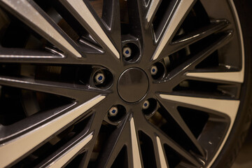 Detailed shot of a sleek black and silver alloy wheel on a motor vehicle