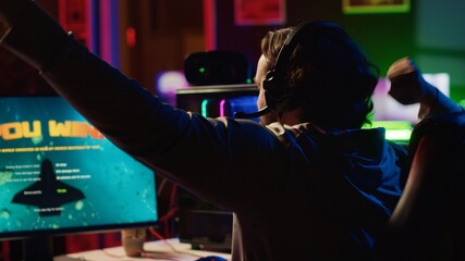 Delighted man celebrating after destroying all enemy spacecrafts and finally winning science...