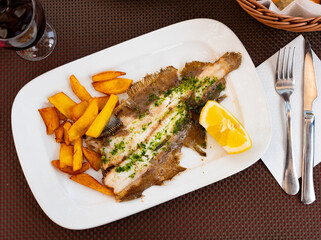 Delicious roasted rooster served on plate potatoes and lemon