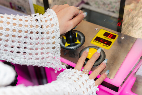 Girl Engaging in Arcade Fun with Joystick Controls