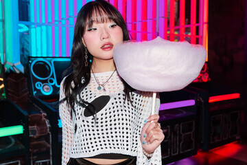 Asian Gen Z Girl Enjoying Vivid Arcade With Cotton Candy