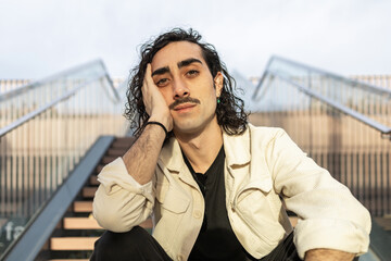 Contemplative man sitting on stairs with relaxed expression