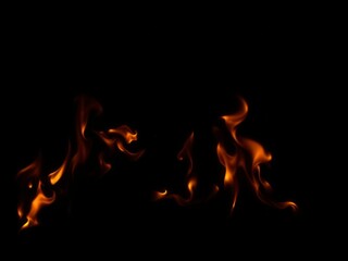 Fototapeta premium Raging fire flames contrasting against a dark black background, background, intensity