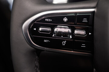 Fototapeta premium The modern cars steering wheel control panel boosts convenience and performance