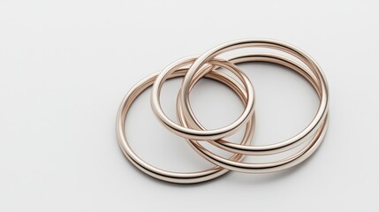 Naklejka premium Interlocked rose gold rings on white background.