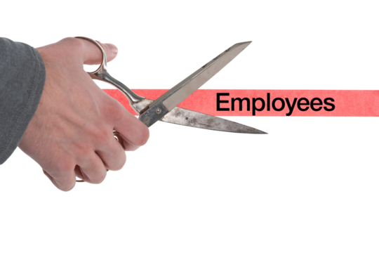 Isolated male hand with scissors cutting through red tape with employees written on it
