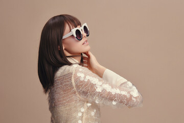 Woman, white shirt, sunglasses a woman in a white shirt and sunglasses looks into the distance with...