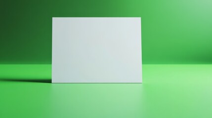Naklejka premium 33.A blank white page centered on a vibrant green surface, with soft shadows giving a subtle depth effect, inviting space for text or imagery, and evoking a feeling of freshness and simplicity.
