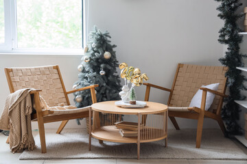 Figure 2025 made of balloons on table in room with armchairs and Christmas tree