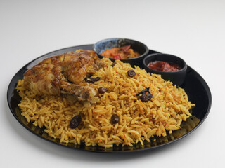 Biryani Rice served with fried chicken on a plate