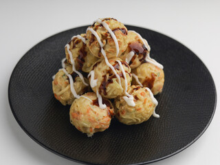Takoyaki balls or noodle balls piled on a plate