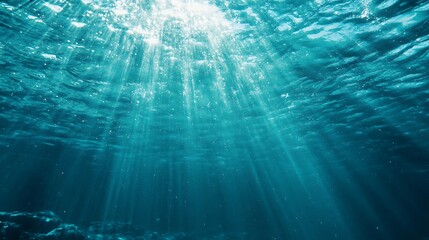 Sunlight beams through the ocean water. Concept of underwater world, marine life, and nature.
