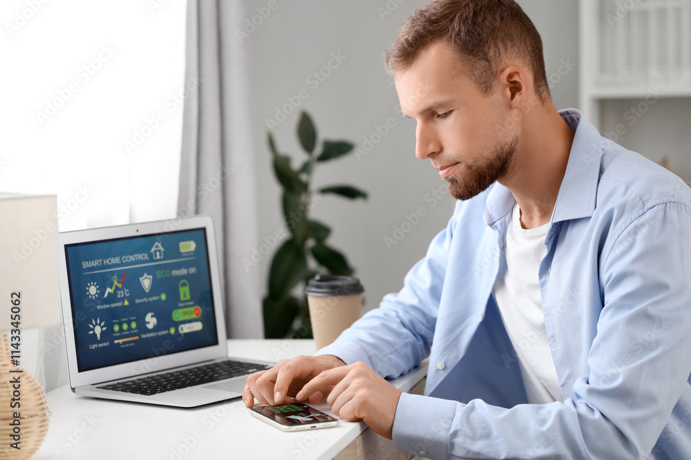 Poster young man using mobile phone with smart home security system application at table in room