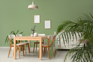 Interior of modern dining room with teapot and cups on table
