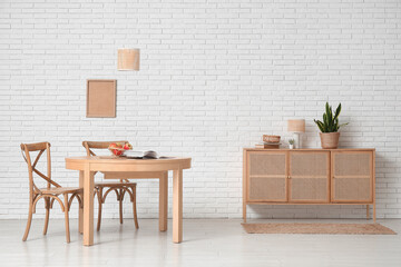 Table with apples and book in interior of dining room