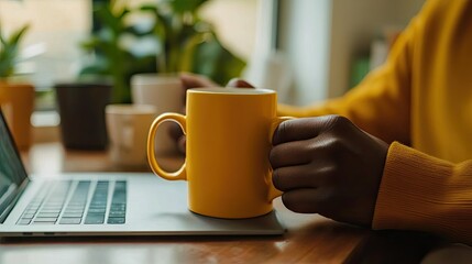Cozy Work From Home Moment: Person Enjoying Coffee Break with Laptop