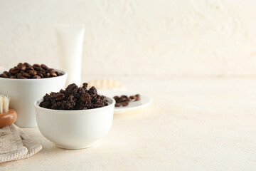Composition with bowls of coffee body scrub and coffee beans on light grunge background
