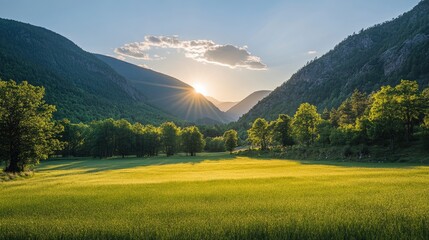 Obraz premium Serene Sunrise Over a Lush Green Valley with Majestic Mountains