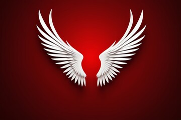 Obraz premium a close up of a white angel wings on a red background