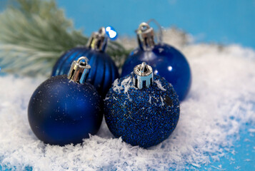 blue christmas balls on snow